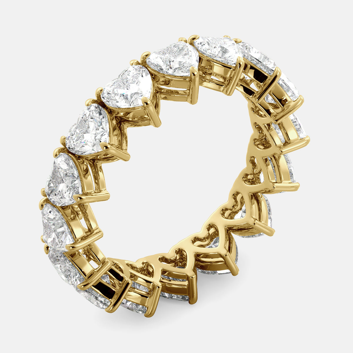 A close-up of a heart-shaped lab-grown diamond eternity wedding band in 14K yellow gold. The band is set with heart shape brilliant diamonds that sparkle and shine. The band is a beautiful and unique choice for a wedding band.