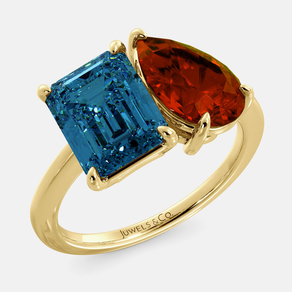 A toi et moi ring with an emerald-cut London Blue Topaz and pear-cut gemstone. The emerald-cut morganite is set on the left of the ring, and the pear-cut gemstone is set on the right. The ring is made of recycled yellow gold and has a simple, elegant design. The pear-cut gemstone can be customized. **Here are some additional details about the image:** * The emerald-cut white London Blue Topaz is a birthstone for December. * The pear-cut gemstone can be customized to any stone of your choice.