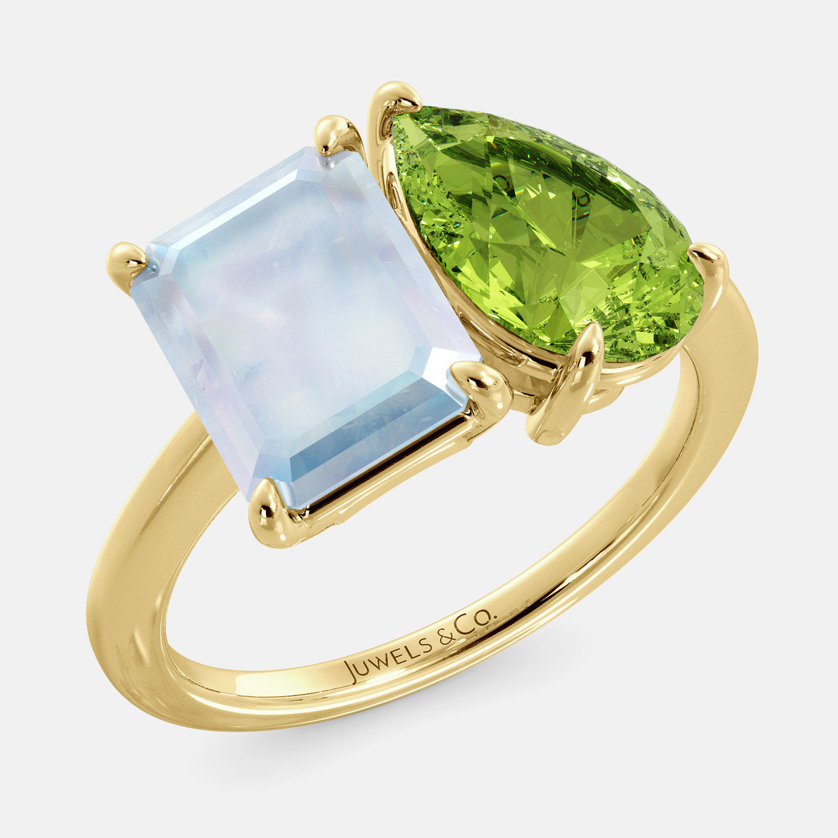 A toi et moi ring with an emerald-cut moonstone and a pear-cut gemstone. The emerald-cut morganite is set on the left of the ring, and the pear-cut gemstone is set on the right. The ring is made of recycled yellow gold and has a simple, elegant design. The pear-cut gemstone can be customized. **Here are some additional details about the image:** * The emerald-cut white moonstone is a birthstone for June. * The pear-cut gemstone can be customized to any stone of your choice.