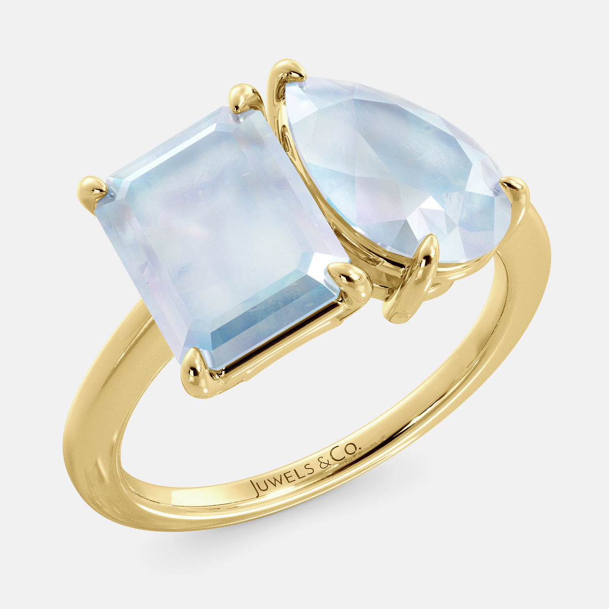 A toi et moi ring with an emerald-cut moonstone and a pear-cut gemstone. The emerald-cut morganite is set on the left of the ring, and the pear-cut gemstone is set on the right. The ring is made of recycled yellow gold and has a simple, elegant design. The pear-cut gemstone can be customized. **Here are some additional details about the image:** * The emerald-cut white moonstone is a birthstone for June. * The pear-cut gemstone can be customized to any stone of your choice.