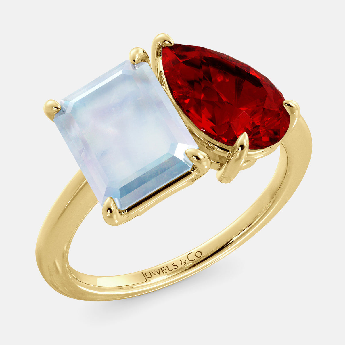 A toi et moi ring with an emerald-cut moonstone and a pear-cut gemstone. The emerald-cut morganite is set on the left of the ring, and the pear-cut gemstone is set on the right. The ring is made of recycled yellow gold and has a simple, elegant design. The pear-cut gemstone can be customized. **Here are some additional details about the image:** * The emerald-cut white moonstone is a birthstone for June. * The pear-cut gemstone can be customized to any stone of your choice.