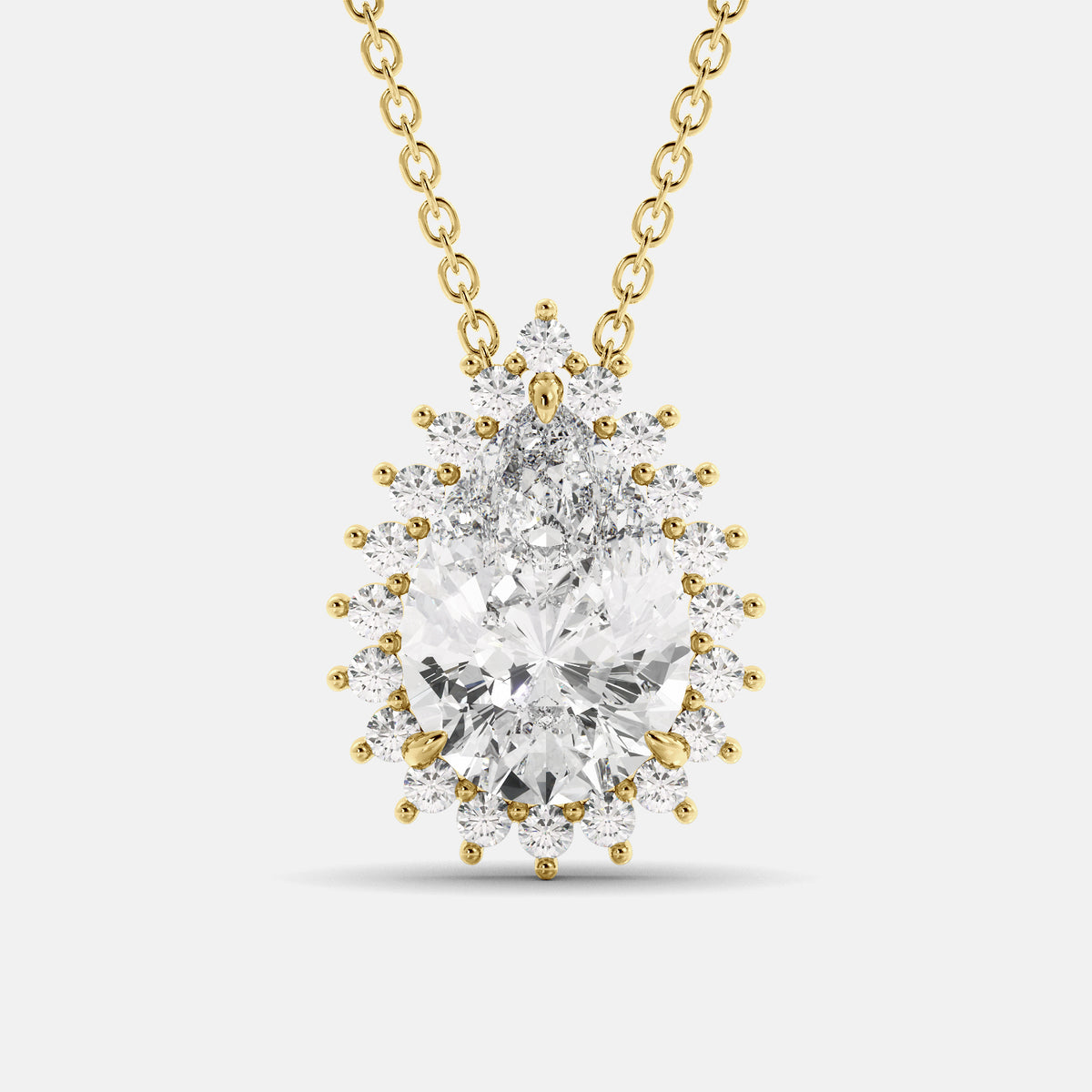 A pear-cut white topaz necklace with a halo of smaller white topaz stones, set in gold.