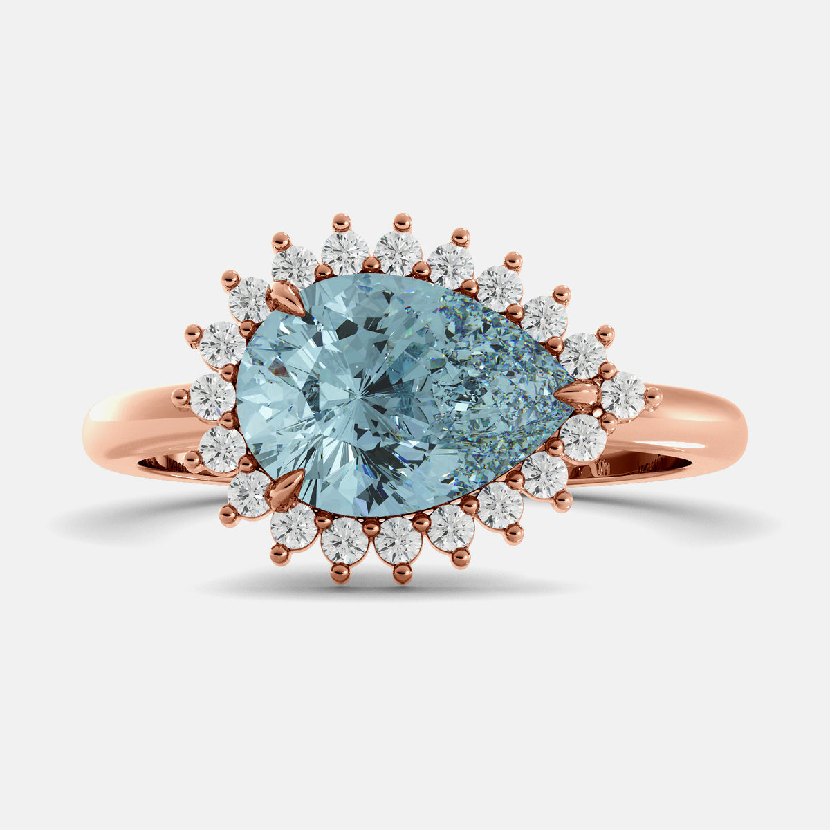 Rose gold ring with a large blue gemstone and smaller diamonds on a light gray background