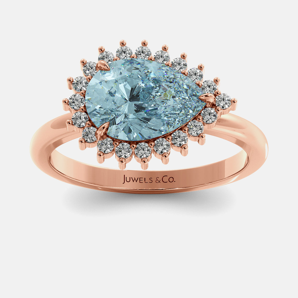 Rose gold ring with a large blue gemstone and smaller diamonds on a white background