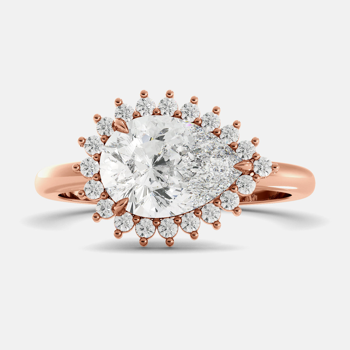 Rose gold ring with a large diamond and smaller diamonds on a light gray background