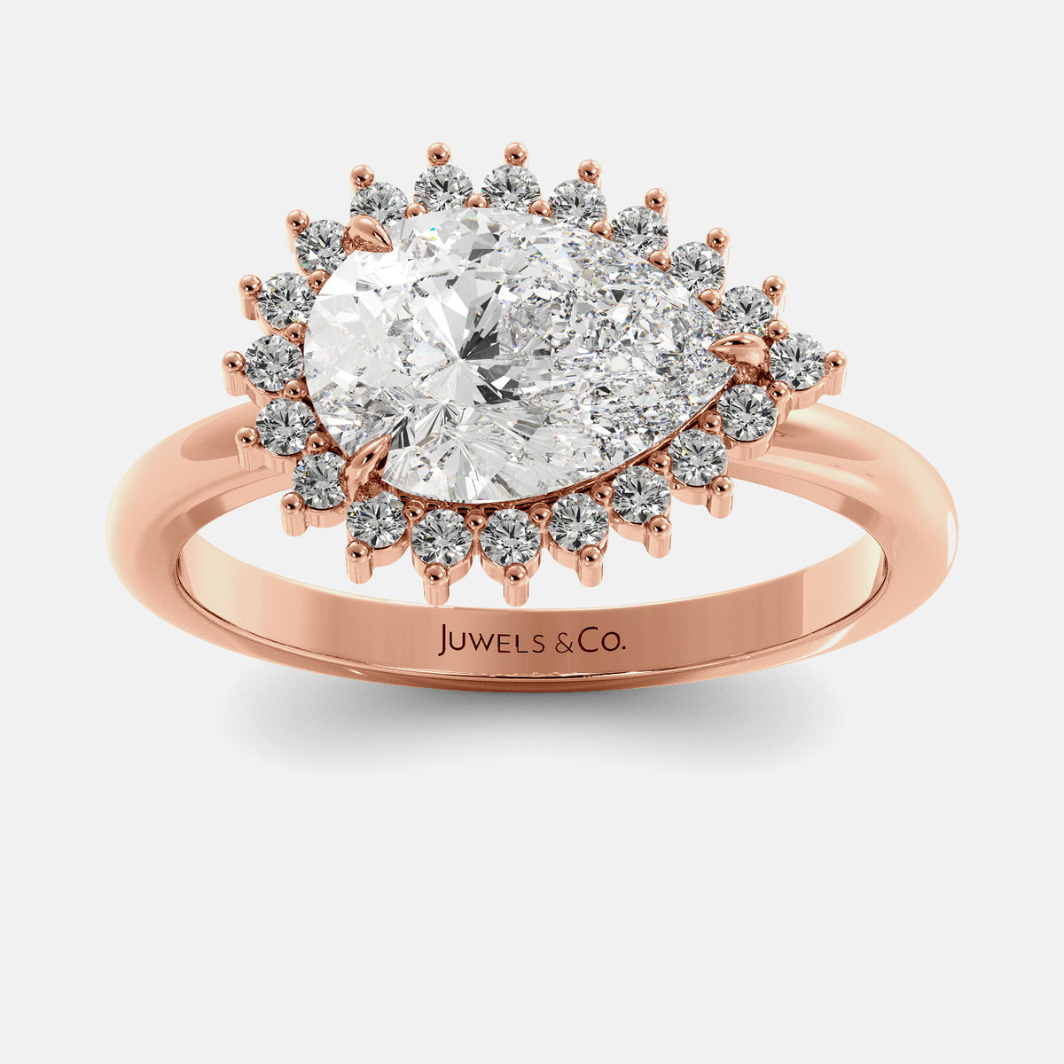 Rose gold ring with a large diamond and smaller diamonds on a white background, featuring the brand 'Juwels & Co'.