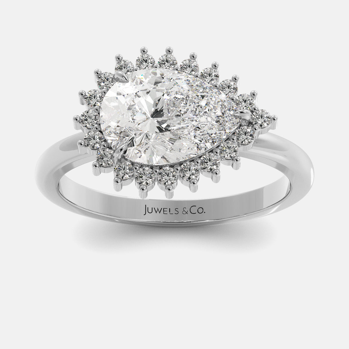 Diamond ring with a halo of smaller diamonds on a white background, branded 'Juwels & Co'.
