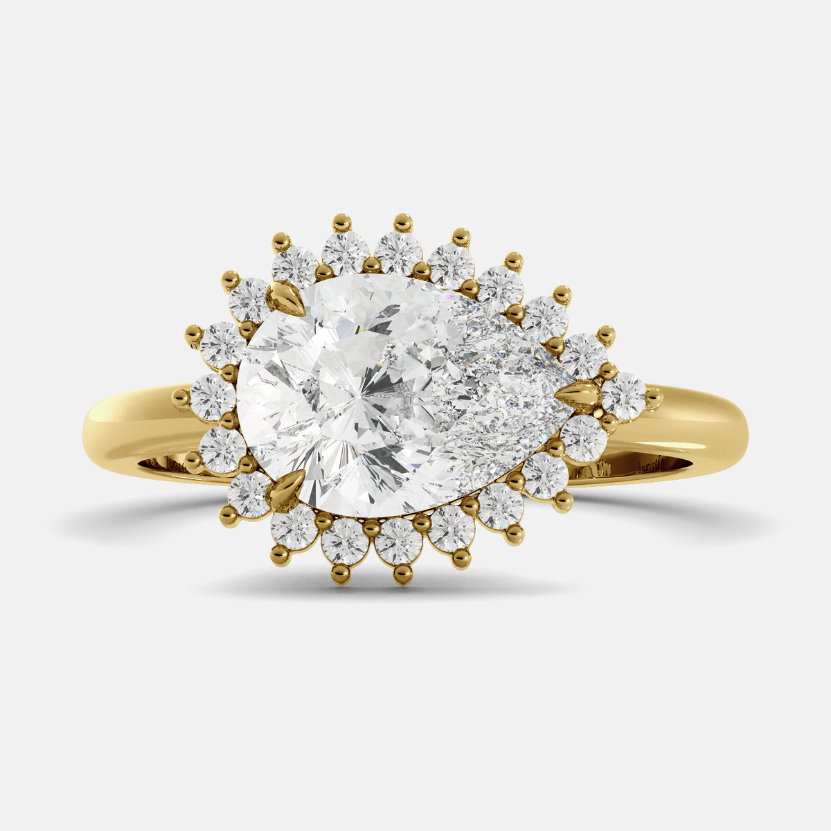 pear cut diamond ring in a halo setting on a white background