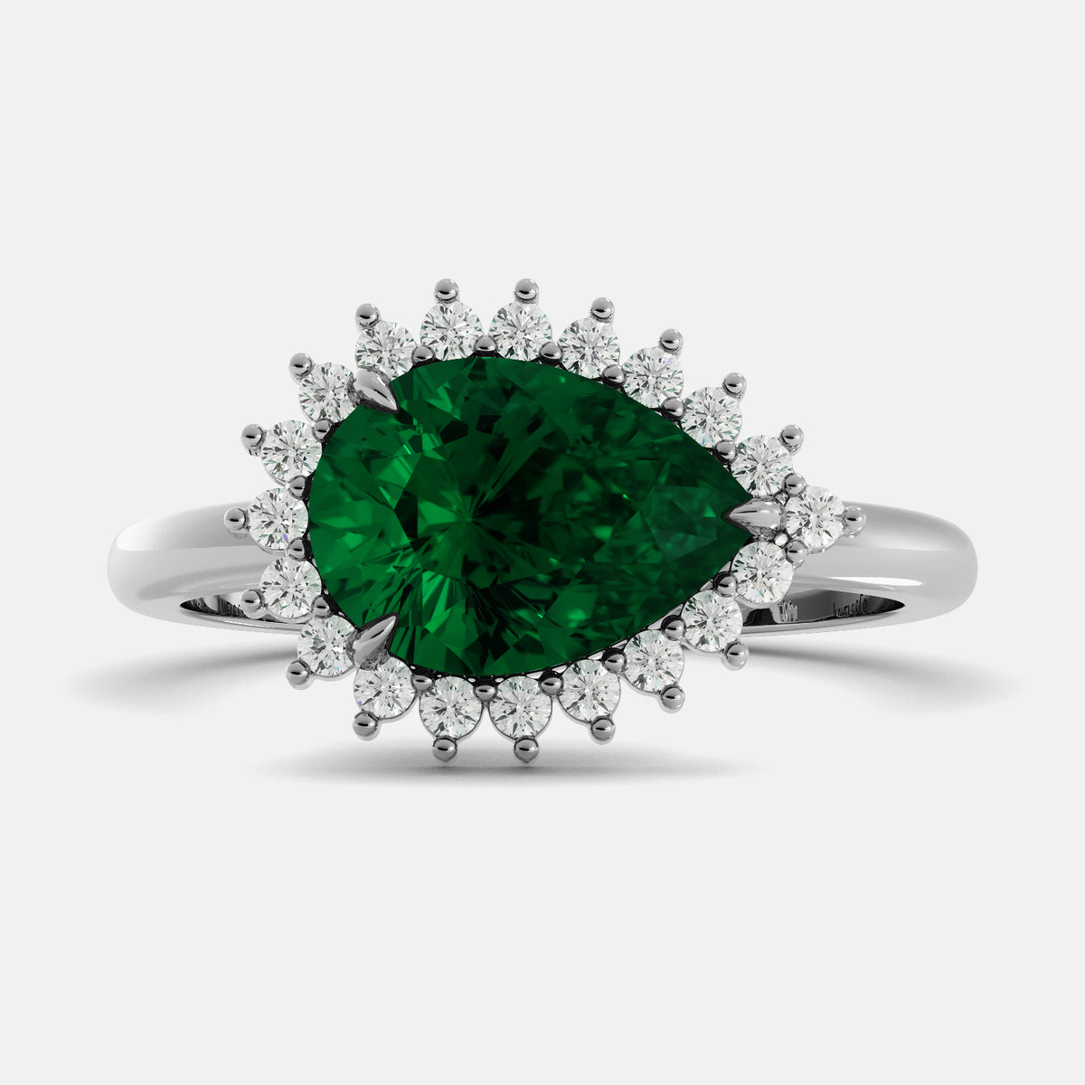 Ring with a green gemstone and diamond accents on a white background