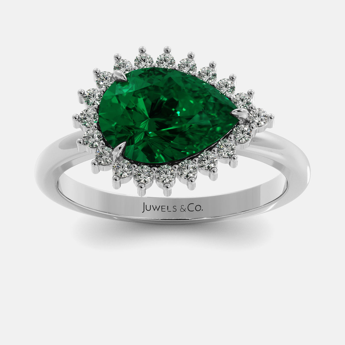 Ring with a emerald and diamond accents on a white background, branded 'Juwels & Co'.
