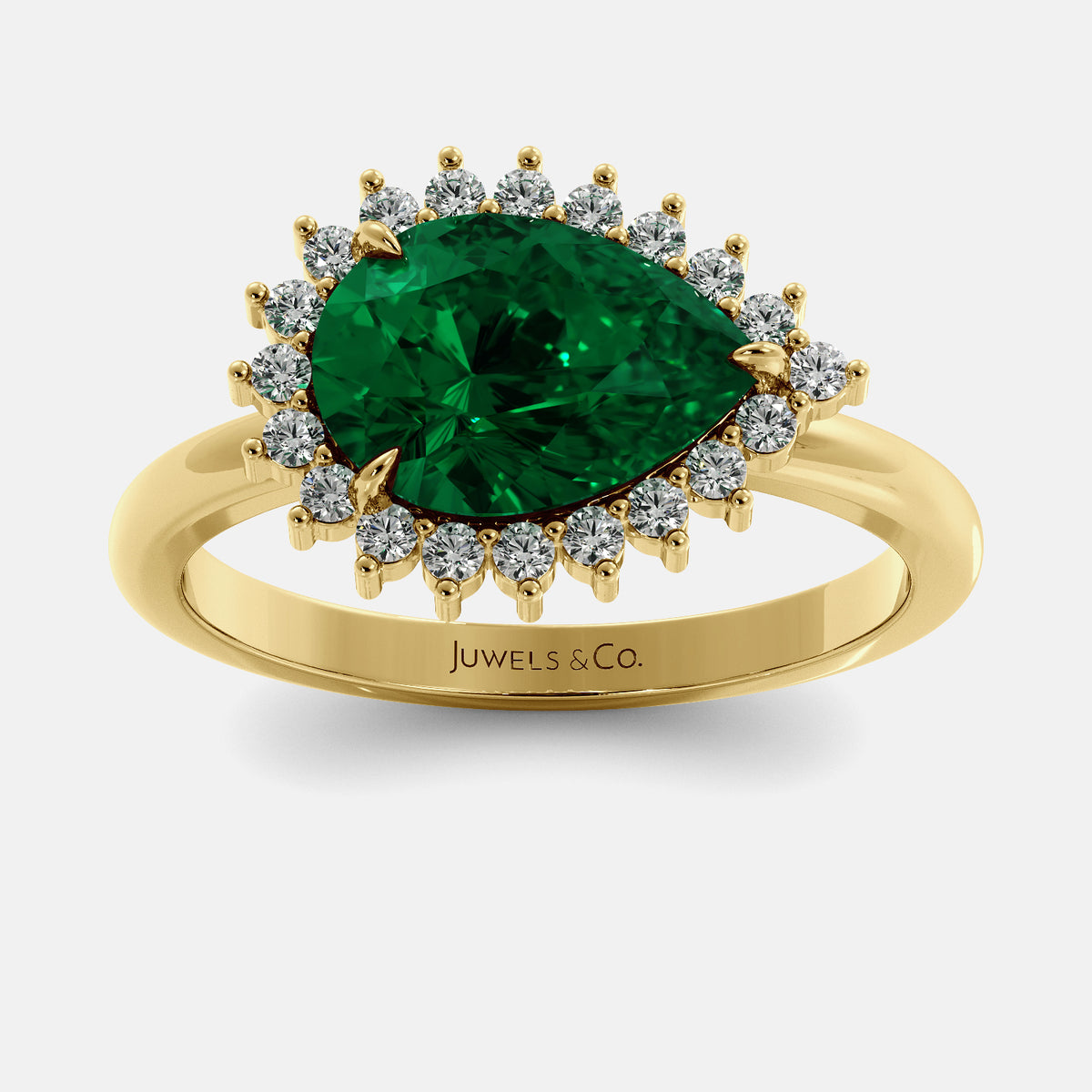 Gold ring with a green gemstone and diamonds on a white background, featuring the brand 'Juwels & Co'.