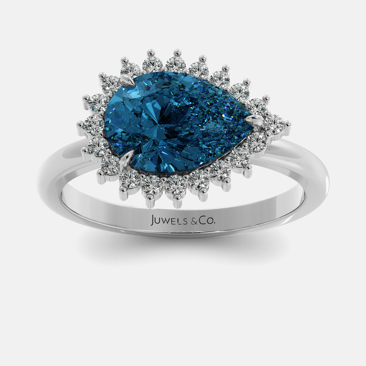 Ring with blue gemstone and diamond accents on a white background, branded 'Juwels & Co'.