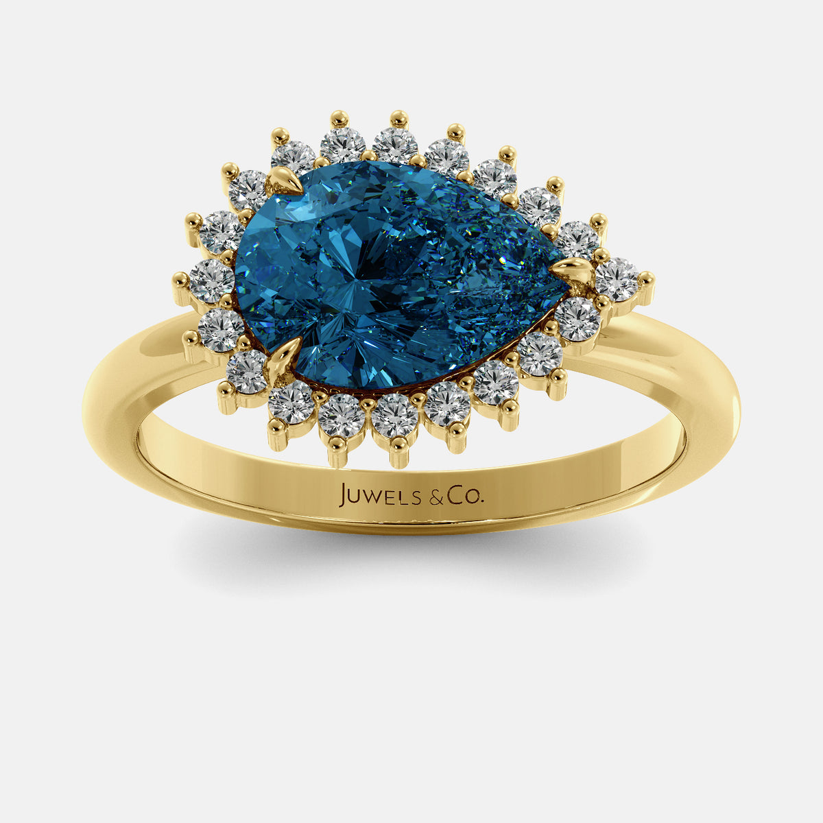Rose gold ring with a blue gemstone and diamonds on a white background, branded 'Juwels & Co'.