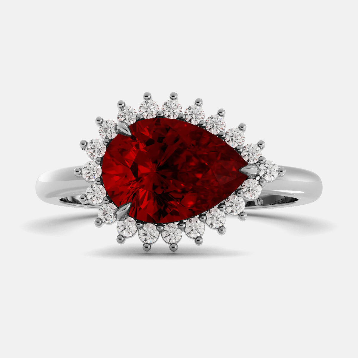 Ring with a red gemstone and diamond accents on a white background