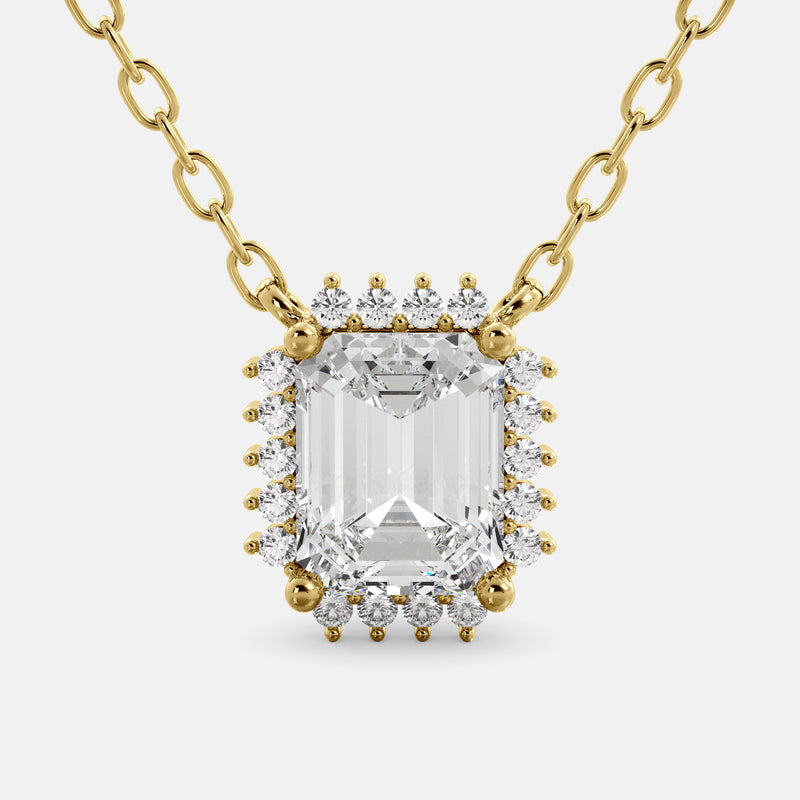 An emerald-cut garnet necklace with a halo of smaller diamonds set in a gold chain.