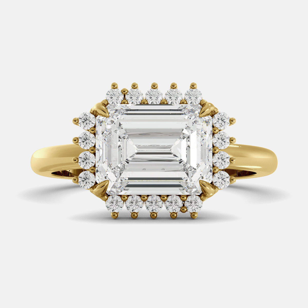 emerald cut diamond ring in a halo setting on a white background