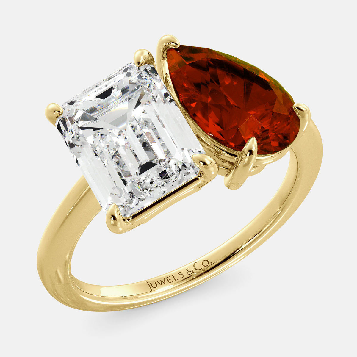 A toi et moi ring with an emerald-cut white topaz and a pear-cut gemstone. The emerald-cut morganite is set on the left of the ring, and the pear-cut gemstone is set on the right. The ring is made of recycled yellow gold and has a simple, elegant design. The pear-cut gemstone can be customized. **Here are some additional details about the image:** * The emerald-cut white topaz is a birthstone for April. * The pear-cut gemstone can be customized to any stone of your choice.