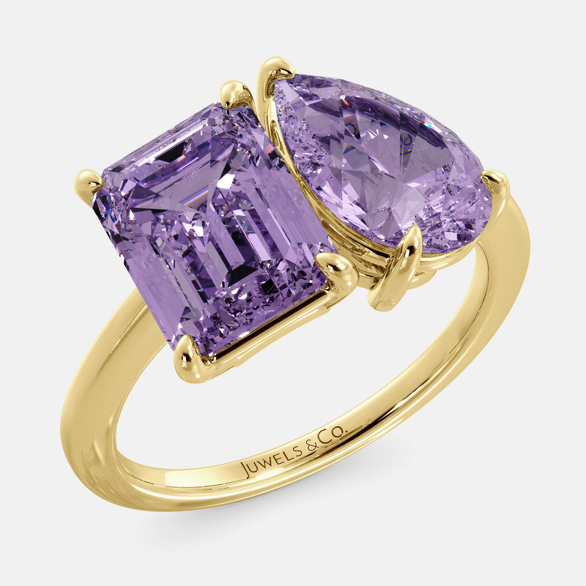 A toi et moi ring with an emerald-cut amethyst and a pear-cut gemstone. The emerald-cut morganite is set on the left of the ring, and the pear-cut gemstone is set on the right. The ring is made of recycled yellow gold and has a simple, elegant design. The pear-cut gemstone can be customized. **Here are some additional details about the image:** * The emerald-cut amethyst is a birthstone for February. * The pear-cut gemstone can be customized to any stone of your choice.