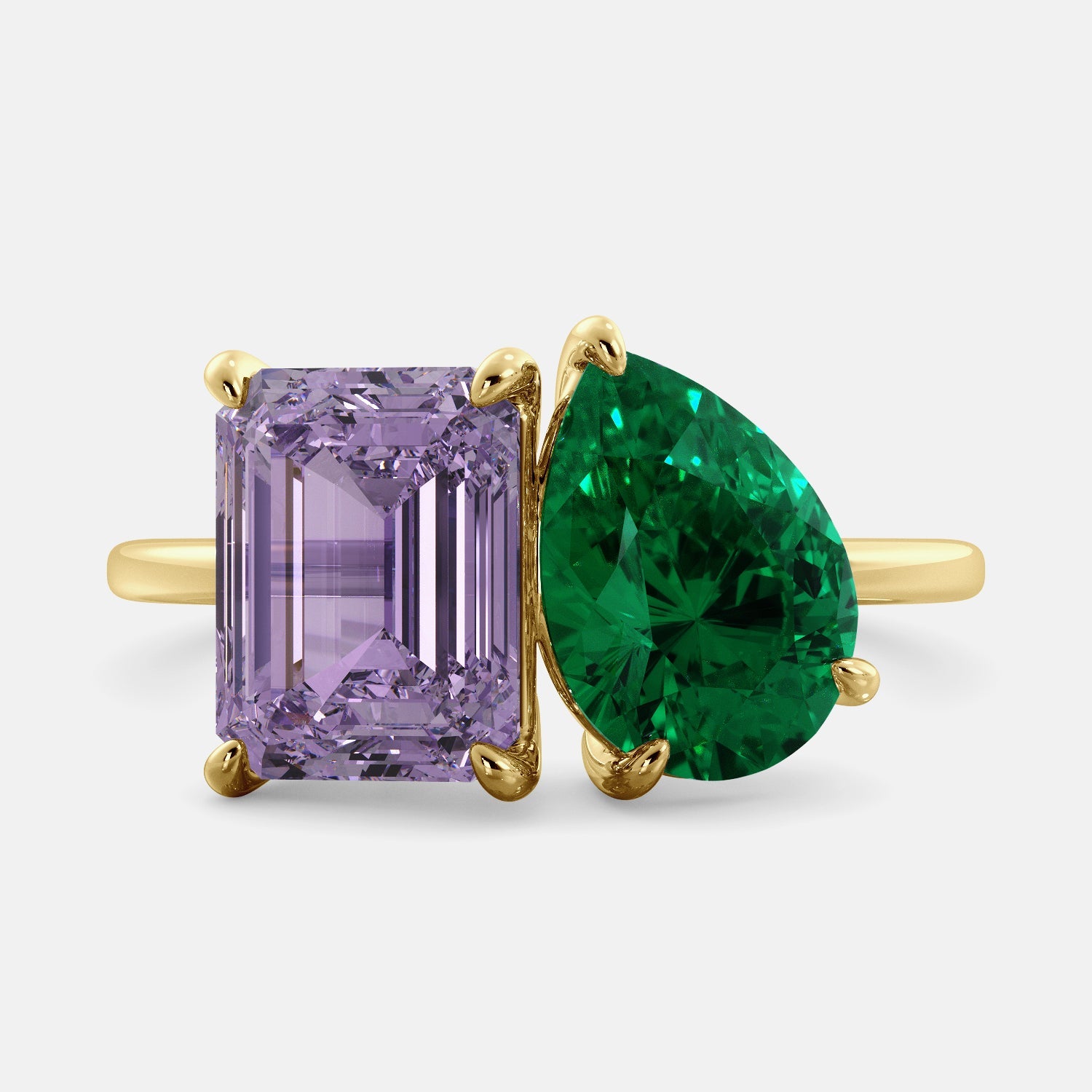 A toi et moi ring with an emerald-cut amethyst and a pear-cut gemstone. The emerald-cut morganite is set on the left of the ring, and the pear-cut gemstone is set on the right. The ring is made of recycled yellow gold and has a simple, elegant design. The pear-cut gemstone can be customized. **Here are some additional details about the image:** * The emerald-cut amethyst is a birthstone for February. * The pear-cut gemstone can be customized to any stone of your choice.