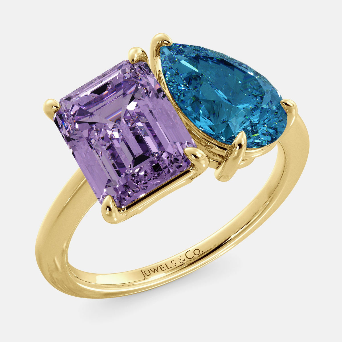 A toi et moi ring with an emerald-cut amethyst and a pear-cut gemstone. The emerald-cut morganite is set on the left of the ring, and the pear-cut gemstone is set on the right. The ring is made of recycled yellow gold and has a simple, elegant design. The pear-cut gemstone can be customized. **Here are some additional details about the image:** * The emerald-cut amethyst is a birthstone for February. * The pear-cut gemstone can be customized to any stone of your choice.