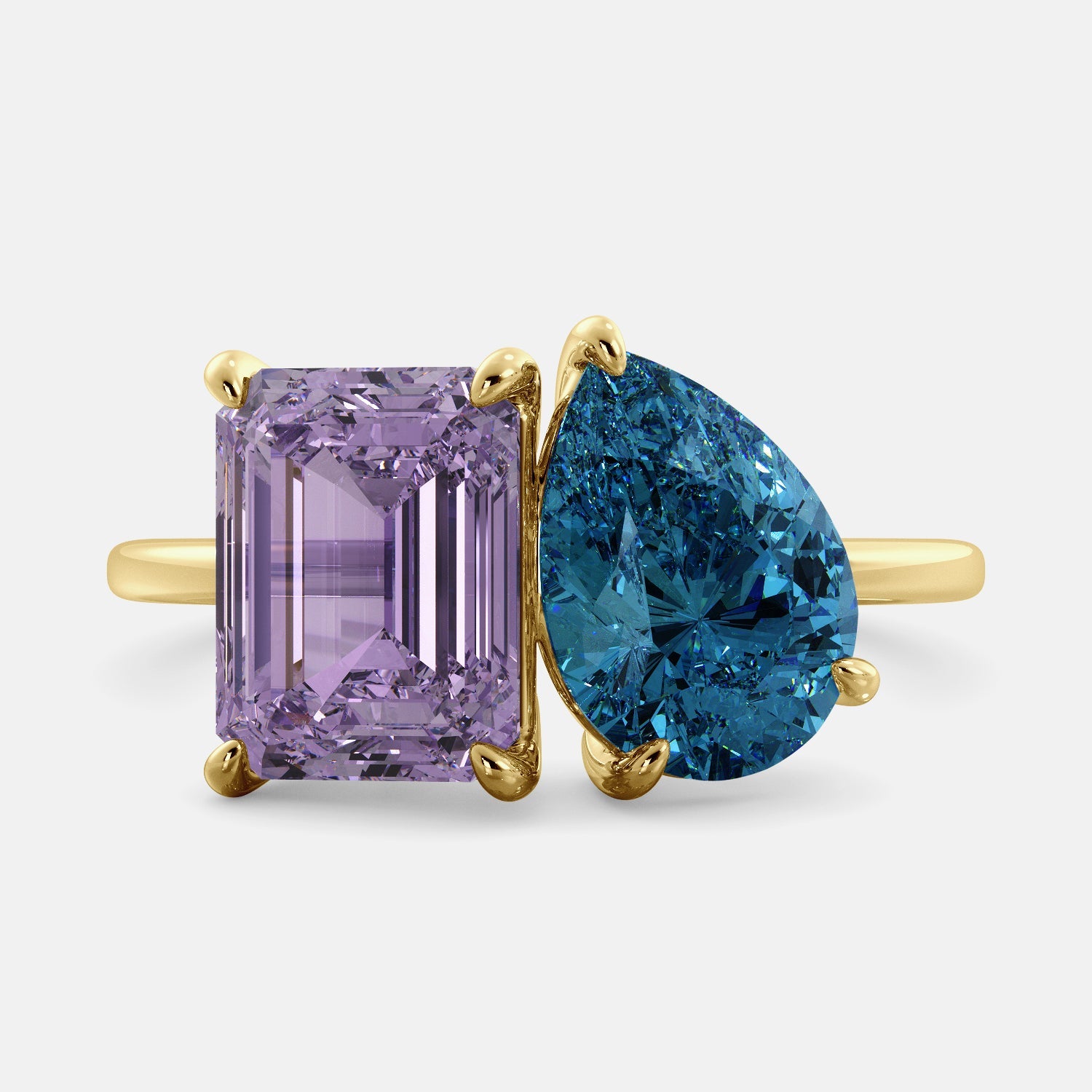 A toi et moi ring with an emerald-cut amethyst and a pear-cut gemstone. The emerald-cut is set on the left of the ring, and the pear-cut gemstone is set on the right. The ring is made of recycled yellow gold and has a simple, elegant design. The pear-cut gemstone can be customized. **Here are some additional details about the image:** * The emerald-cut amethyst is a birthstone for February. * The pear-cut gemstone can be customized to any stone of your choice.