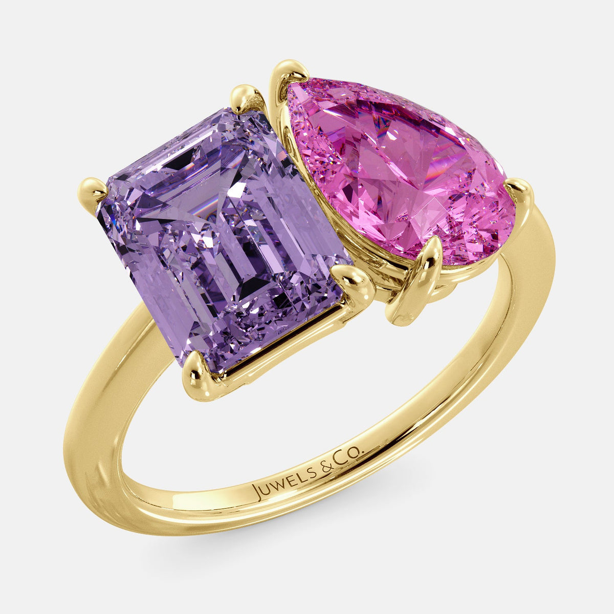 A toi et moi ring with an emerald-cut amethyst and a pear-cut gemstone. The emerald-cut morganite is set on the left of the ring, and the pear-cut gemstone is set on the right. The ring is made of recycled yellow gold and has a simple, elegant design. The pear-cut gemstone can be customized. **Here are some additional details about the image:** * The emerald-cut amethyst is a birthstone for February. * The pear-cut gemstone can be customized to any stone of your choice.