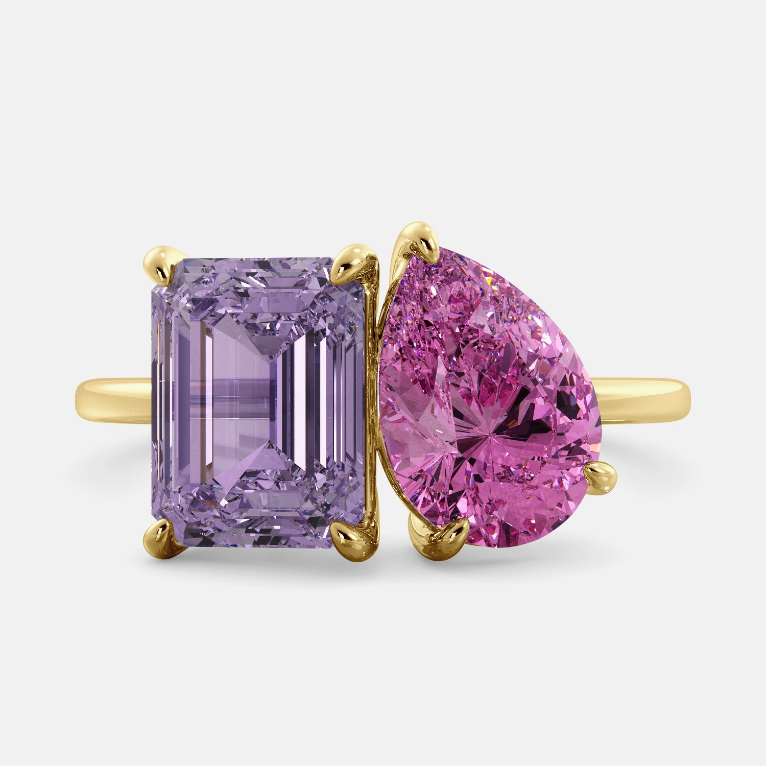 A toi et moi ring with an emerald-cut amethyst and a pear-cut gemstone. The emerald-cut morganite is set on the left of the ring, and the pear-cut gemstone is set on the right. The ring is made of recycled yellow gold and has a simple, elegant design. The pear-cut gemstone can be customized. **Here are some additional details about the image:** * The emerald-cut amethyst is a birthstone for February. * The pear-cut gemstone can be customized to any stone of your choice.