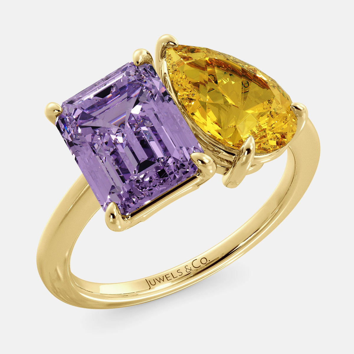 A toi et moi ring with an emerald-cut amethyst and a pear-cut gemstone. The emerald-cut morganite is set on the left of the ring, and the pear-cut gemstone is set on the right. The ring is made of recycled yellow gold and has a simple, elegant design. The pear-cut gemstone can be customized. **Here are some additional details about the image:** * The emerald-cut amethyst is a birthstone for February. * The pear-cut gemstone can be customized to any stone of your choice.