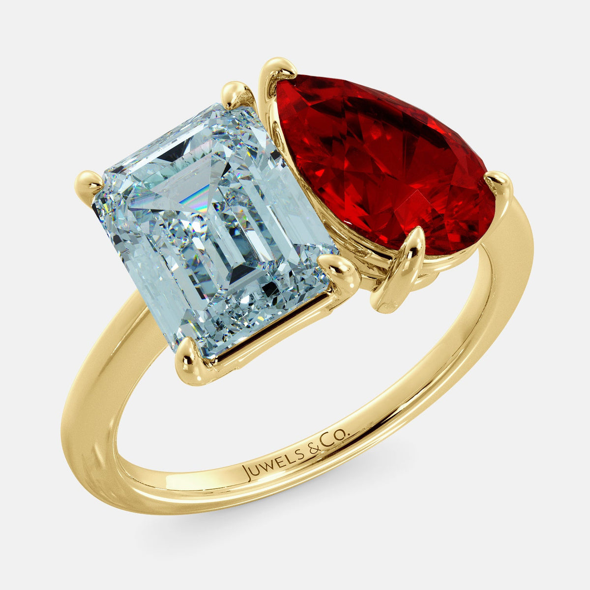 A toi et moi ring with an emerald-cut aquamarine and a pear-cut gemstone. The emerald-cut morganite is set on the left of the ring, and the pear-cut gemstone is set on the right. The ring is made of recycled yellow gold and has a simple, elegant design. The pear-cut gemstone can be customized. **Here are some additional details about the image:** * The emerald-cut aquamarine is a birthstone for March. * The pear-cut gemstone can be customized to any stone of your choice.