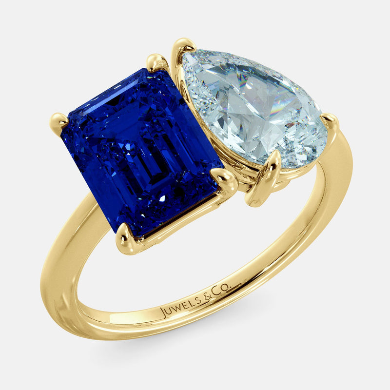 Toi et Moi ring with an emerald-cut Blue Sapphire and a pear-cut Aquamarine.