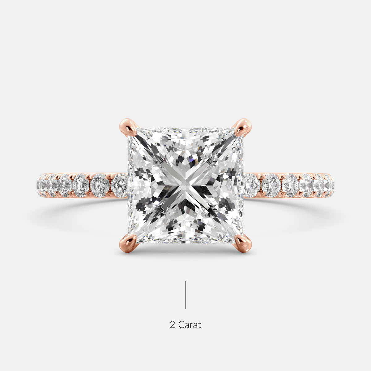 A close-up of a rose gold cushion solitaire lab-grown diamond ring with an eternity band. The lab-grown diamond is a climate -positive diamond, created by using carbon from the atmosphere. The ring is set with a 1-carat cushion-cut diamond in the center, surrounded by a row of smaller diamonds on the band. The ring is available in a variety of sizes and starts at \\$6,400.00.