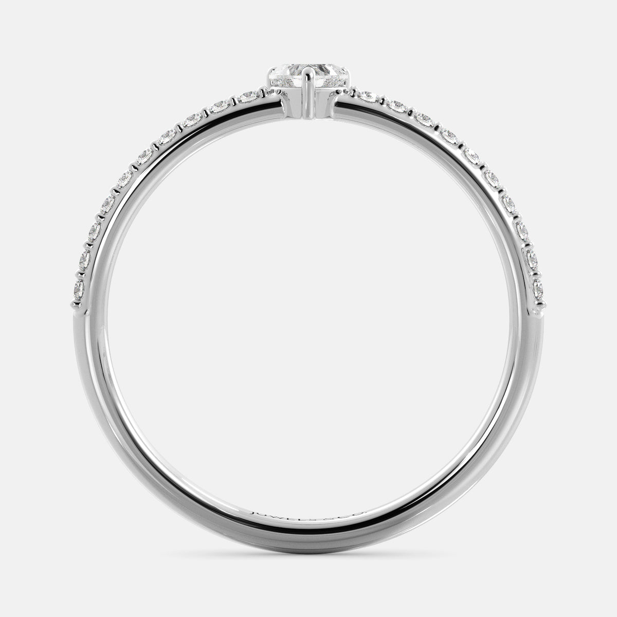 A close-up of a heart-shaped diamond ring with side stones in recycled white gold. The ring is set with a single, large diamond in the center of a heart-shaped setting. The ring is made of recycled yellow gold and has a simple, elegant design. The diamond is sparkling and reflects light beautifully. The side stones are smaller diamonds that are set in the band of the ring. The ring is a perfect gift for a loved one or a special occasion.