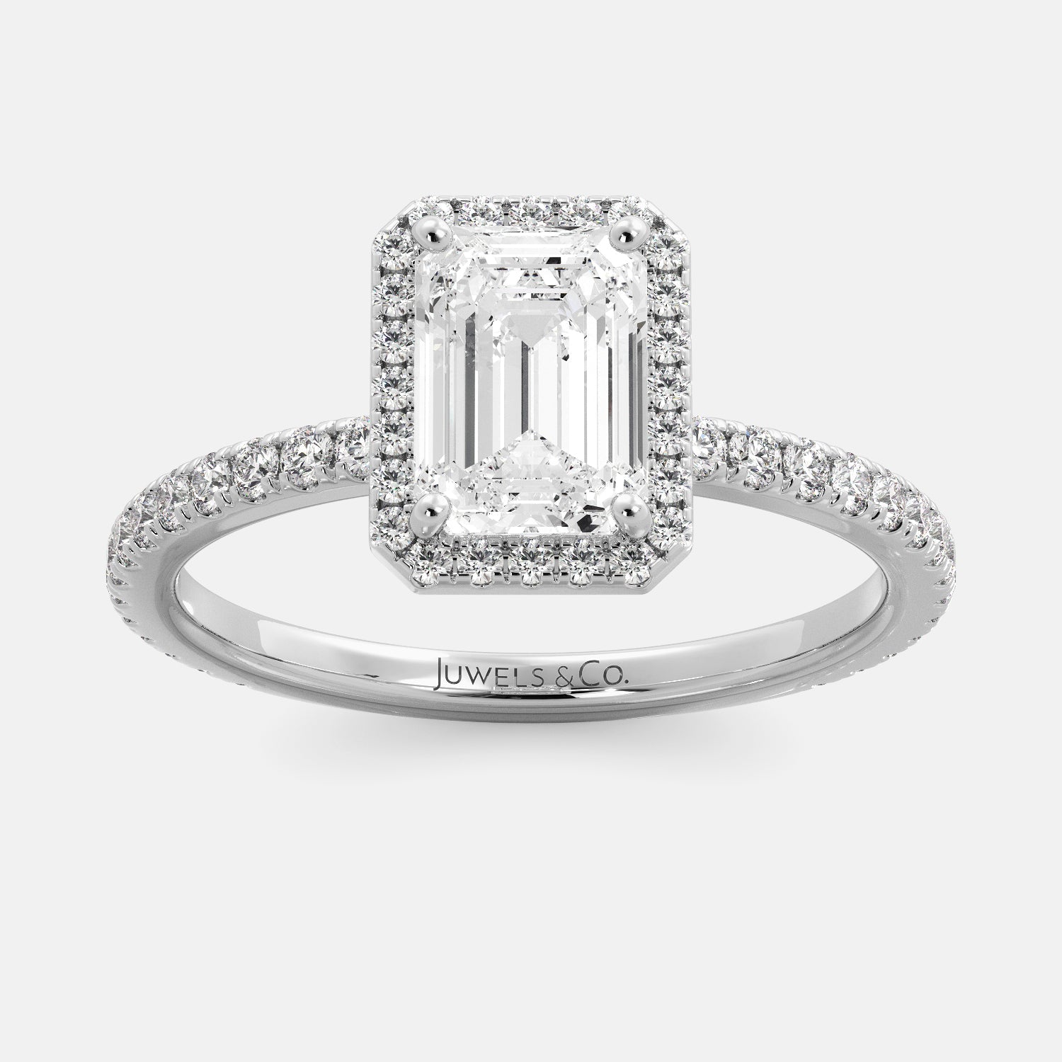 This image shows a stunning emerald halo lab-grown diamond ring with pavé on a white gold band. The ring features a 1.5-carat emerald-cut lab-grown diamond in the center, surrounded by a halo of smaller lab-grown diamonds. The ring is made of 14k white gold and is available in a variety of sizes.