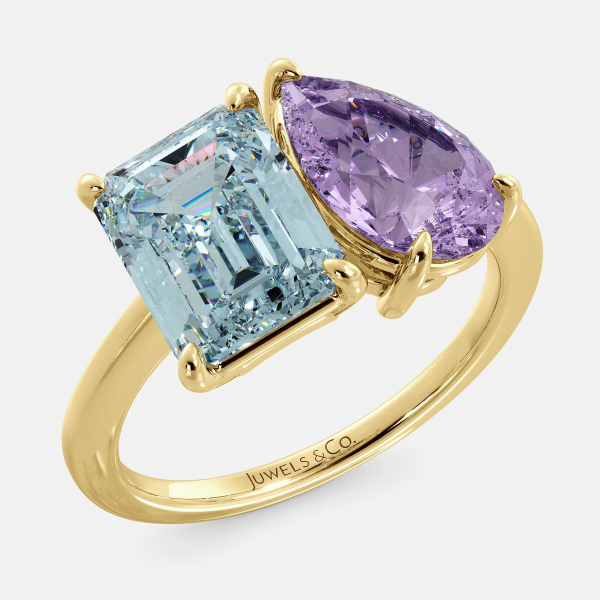 A toi et moi ring with an emerald cut aquamarine and a pear cut amethyst. The ring is set in a 14k yellow gold band and is available in all sizes. Aquamarine is a blue gemstone that is said to promote spiritual growth and strengthen self-confidence. Amethyst is a purple gemstone that is said to promote peace, love, and harmony. The toi et moi ring is a beautiful and unique way to show your love and commitment to someone special.