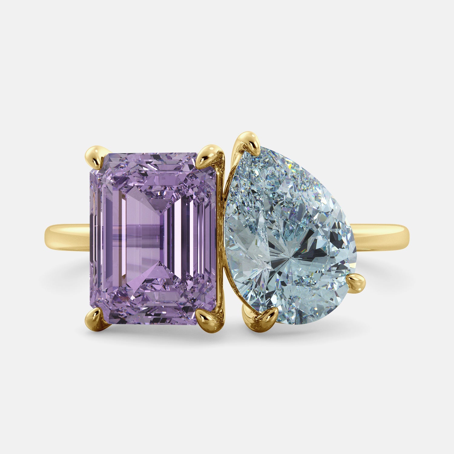 A toi et moi ring with a pear-shaped aquamarine and an emerald-cut amethyst. The ring is set in a 14k yellow gold band and is available in all sizes. The aquamarine is a blue gemstone that is said to promote spiritual growth and strengthen self-confidence. The amethyst is a purple gemstone that is said to promote peace, love, and harmony. The toi et moi ring is a beautiful and unique way to show your love and commitment to someone special.