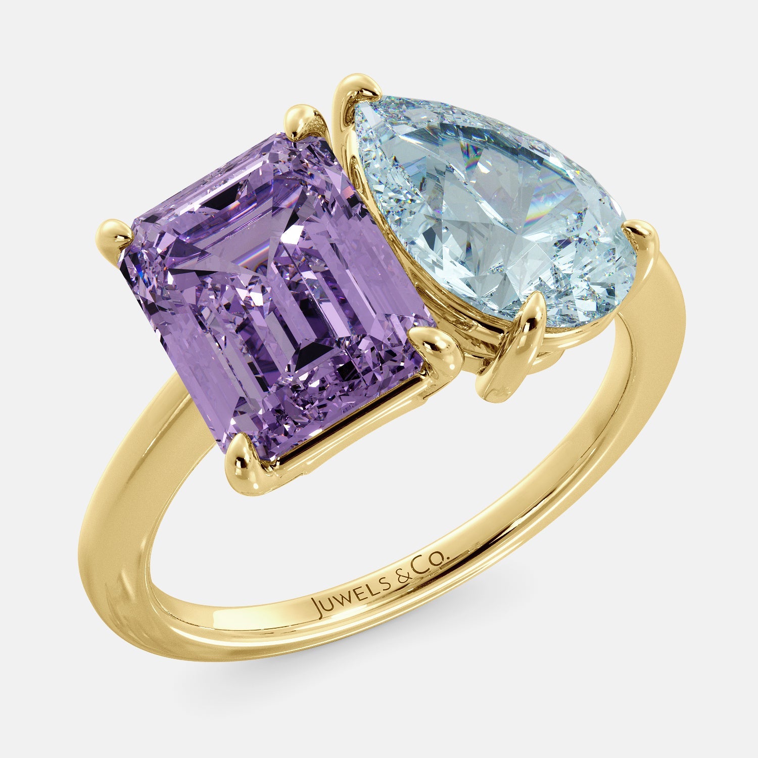 A toi et moi ring with a pear-shaped aquamarine and an emerald-cut amethyst. The ring is set in a 14k yellow gold band and is available in all sizes. The aquamarine is a blue gemstone that is said to promote spiritual growth and strengthen self-confidence. The amethyst is a purple gemstone that is said to promote peace, love, and harmony. The toi et moi ring is a beautiful and unique way to show your love and commitment to someone special.