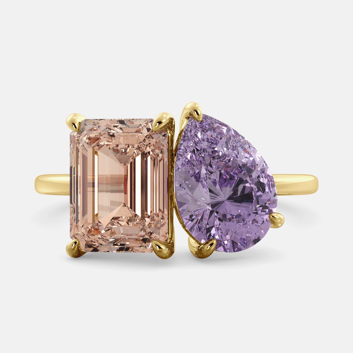 A toi et moi ring with a pear-shaped amethyst and an emerald-cut morganite. The ring is set in a 14k yellow gold band and is available in all sizes. The morganite is a pink gemstone that is said to promote love, compassion, and forgiveness. The amethyst is a purple gemstone that is said to promote peace, love, and harmony. The toi et moi ring is a beautiful and unique way to show your love and commitment to someone special.
