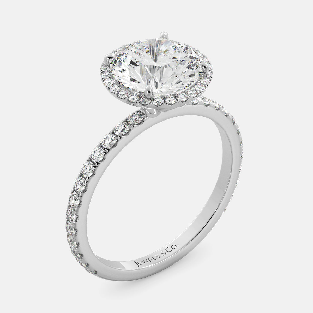 This image shows a beautiful round halo lab-diamond ring with pavé on a white gold band. The ring features a round brilliant-cut lab diamond in the center, surrounded by a halo of smaller diamonds. The band is pavé-set with smaller diamonds, creating a sparkling and elegant look. The ring is made of 14k white gold and is available in a variety of sizes.