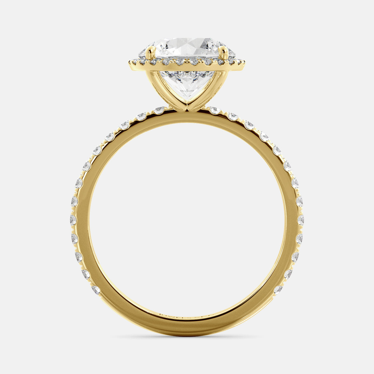 This image shows a beautiful round halo lab-diamond ring with pavé on a yellow gold band. The ring features a round brilliant-cut lab diamond in the center, surrounded by a halo of smaller diamonds. The band is pavé-set with smaller diamonds, creating a sparkling and elegant look. The ring is made of 14k yellow gold and is available in a variety of sizes.