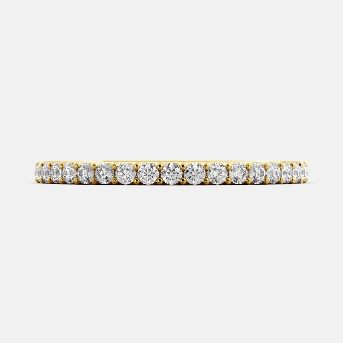A close-up of a yellow gold half eternity wedding band with a row of round diamonds. The band is a classic and timeless design that is perfect for any occasion. The diamonds sparkle and shine, adding a touch of glamour.