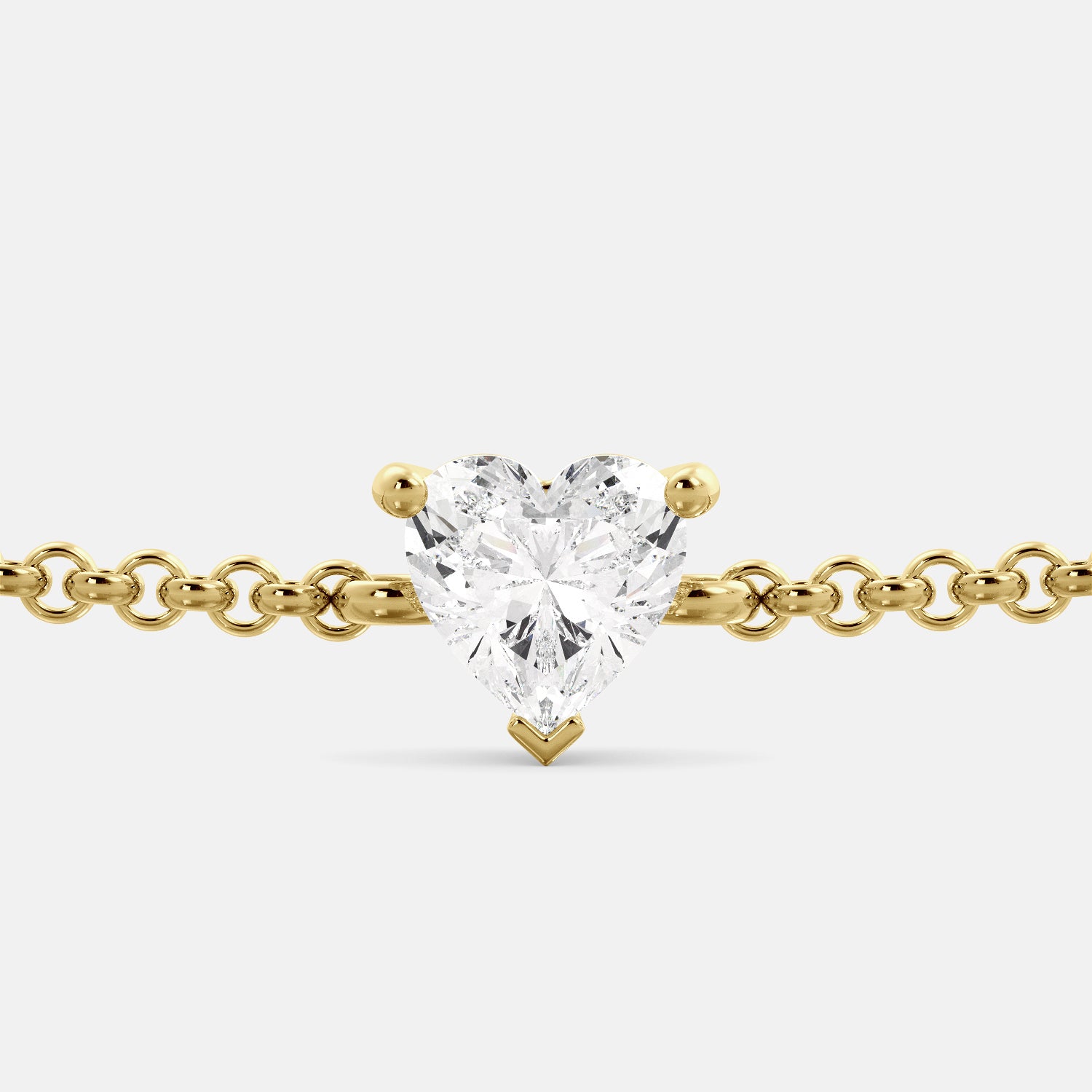 A close-up of a heart-shaped diamond bracelet in recycled yellow gold. The bracelet is set with a single, large diamond in the center of a heart-shaped pendant. The bracelet is made of recycled yellow gold and has a simple, elegant design. The diamond is sparkling and reflects light beautifully. The bracelet is a perfect gift for a loved one or a special occasion.