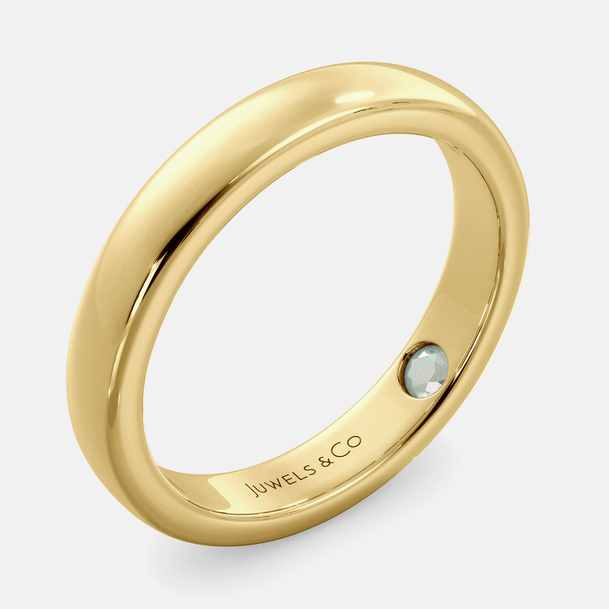 A close-up of a yellow gold flat wedding band with a hidden stone. The band is a classic and timeless design that is perfect for any occasion. The hidden stone can be customized with one of 12 different gemstones, including diamonds, rubies, sapphires, and emeralds. This makes the band a unique and personal choice for the wearer.