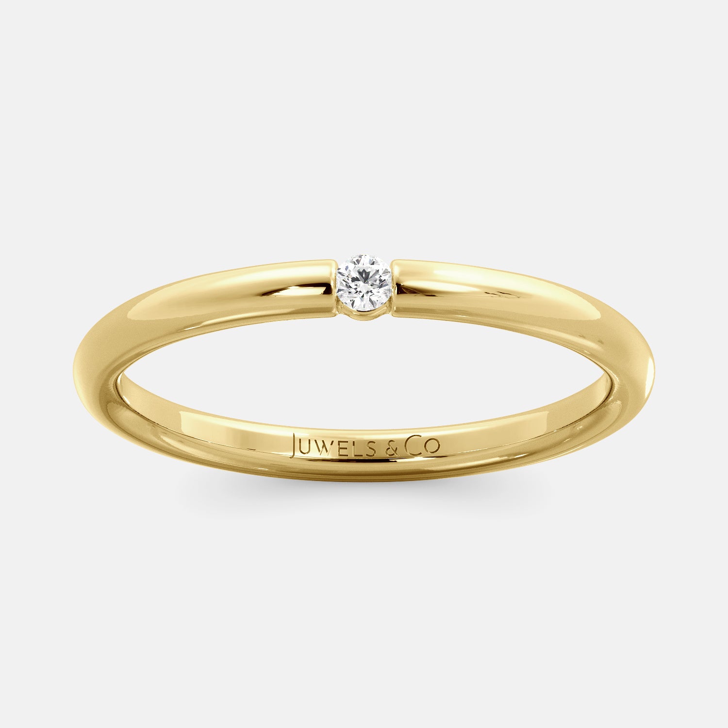 A close-up of a simple round wedding band in 14K yellow gold with a small round diamond in the center. The band is a classic and timeless design that is perfect for any occasion. The diamond is a beautiful accent that adds a touch of glamour.