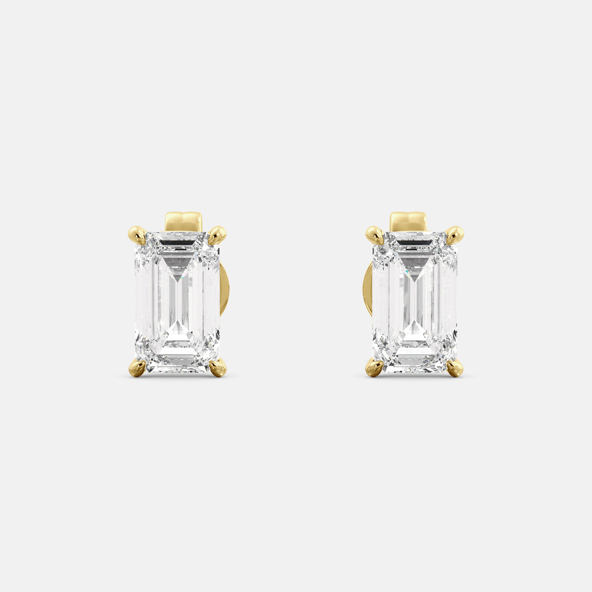 Emerald-cut diamond stud earrings in yellow gold, handmade by Juwels & Co.