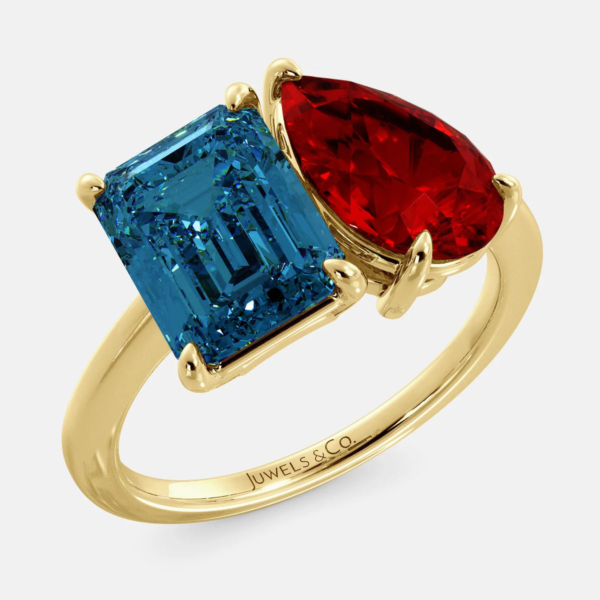 A toi et moi ring with an emerald-cut London Blue Topaz and pear-cut gemstone. The emerald-cut morganite is set on the left of the ring, and the pear-cut gemstone is set on the right. The ring is made of recycled yellow gold and has a simple, elegant design. The pear-cut gemstone can be customized. **Here are some additional details about the image:** * The emerald-cut white London Blue Topaz is a birthstone for December. * The pear-cut gemstone can be customized to any stone of your choice.