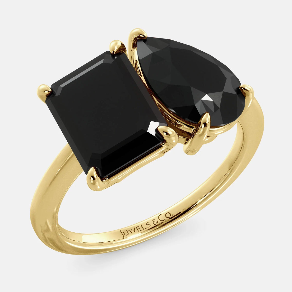 A toi et moi ring with a onyx stone in emerald cut and a pear-shaped stone. The onyx is a deep dark color and the pear-shaped stone can be customized to represent the birth month stone of the wearer or a loved one. The ring is made of 14k gold and is available in all sizes. This ring is a perfect gift for any occasion, and it can be customized to make it truly unique.