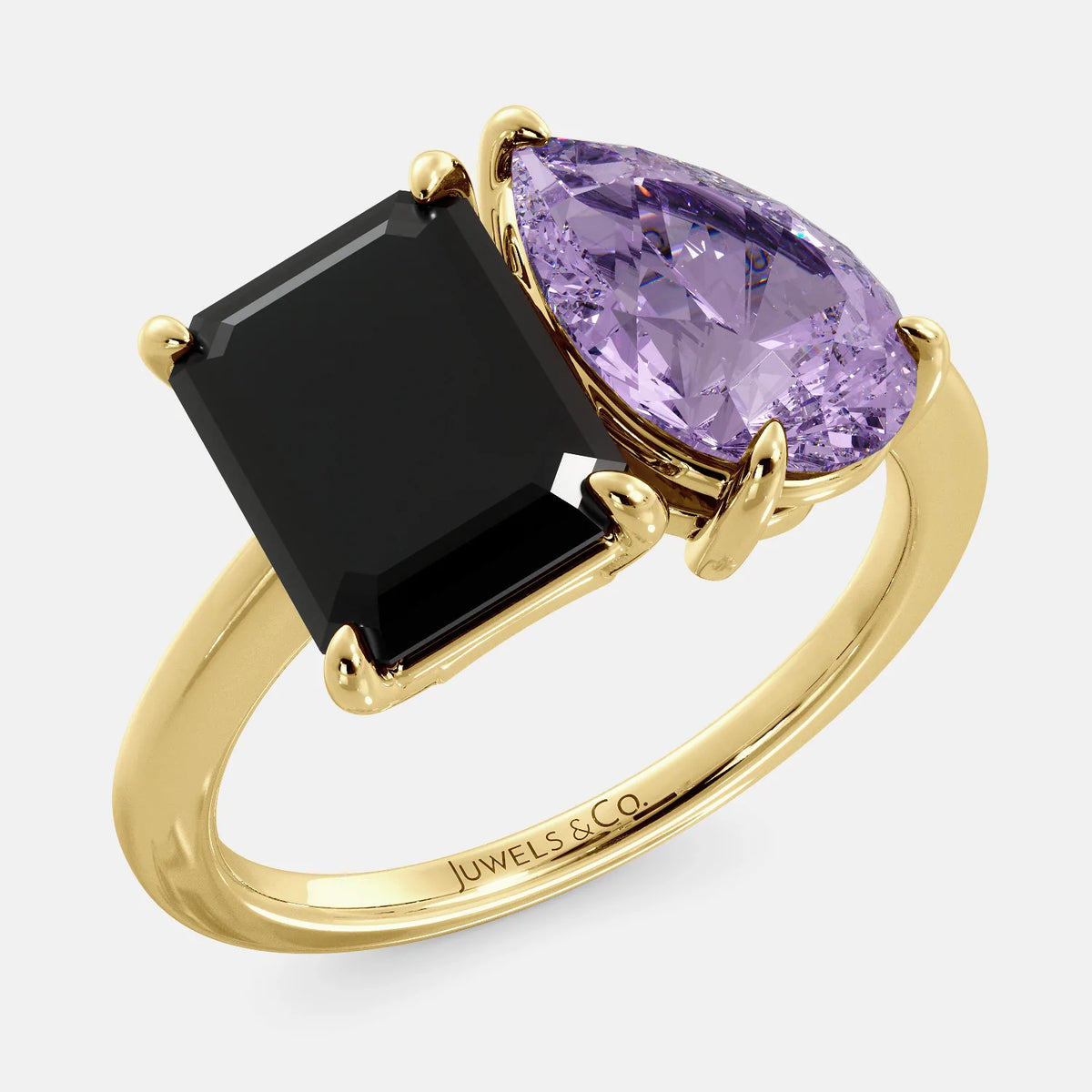 A toi et moi ring with a onyx stone in emerald cut and a pear-shaped stone. The onyx is a deep dark color and the pear-shaped stone can be customized to represent the birth month stone of the wearer or a loved one. The ring is made of 14k gold and is available in all sizes. This ring is a perfect gift for any occasion, and it can be customized to make it truly unique.