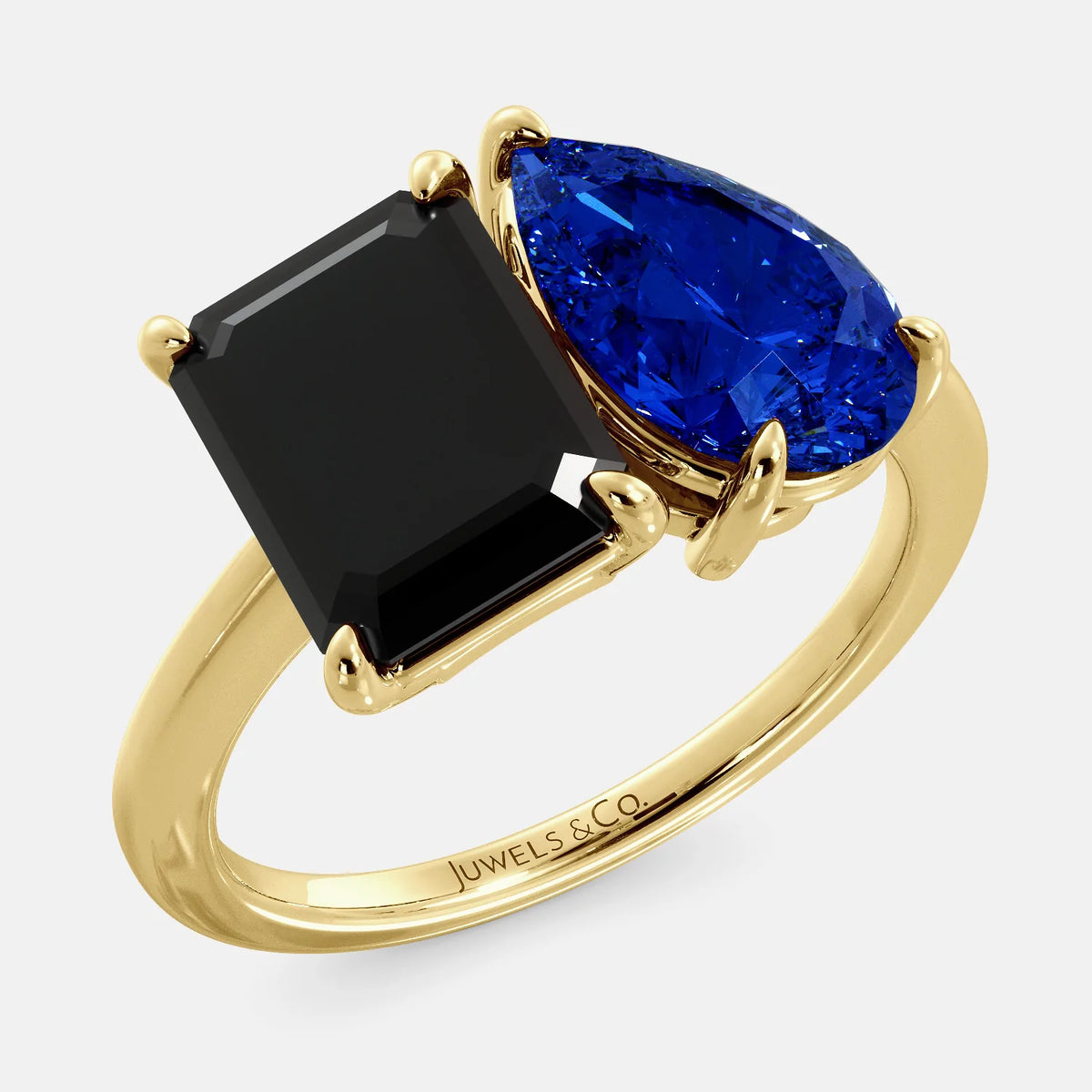 A toi et moi ring with a onyx stone in emerald cut and a pear-shaped stone. The onyx is a deep dark color and the pear-shaped stone can be customized to represent the birth month stone of the wearer or a loved one. The ring is made of 14k gold and is available in all sizes. This ring is a perfect gift for any occasion, and it can be customized to make it truly unique.