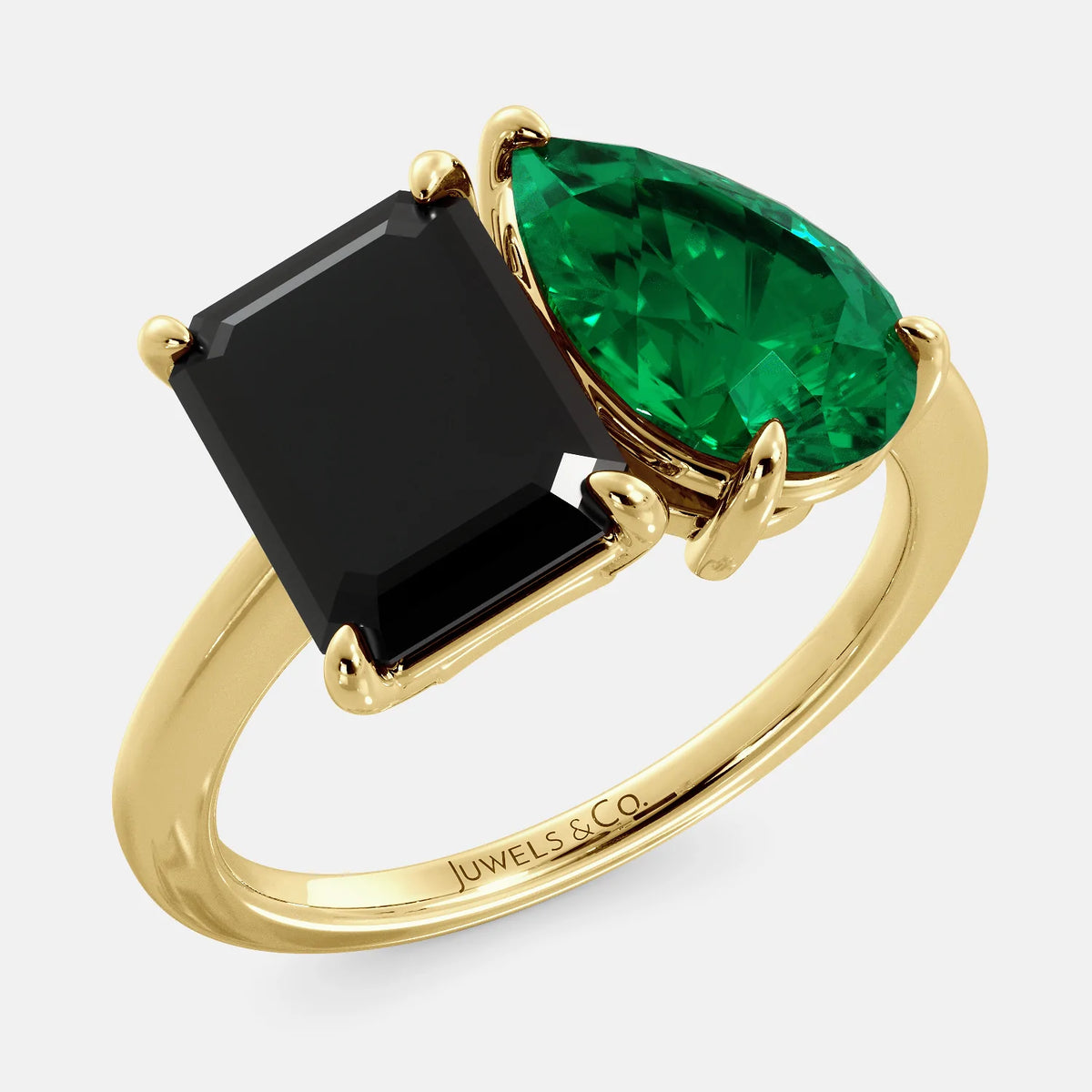 A toi et moi ring with a onyx stone in emerald cut and a pear-shaped stone. The onyx is a deep dark color and the pear-shaped stone can be customized to represent the birth month stone of the wearer or a loved one. The ring is made of 14k gold and is available in all sizes. This ring is a perfect gift for any occasion, and it can be customized to make it truly unique.