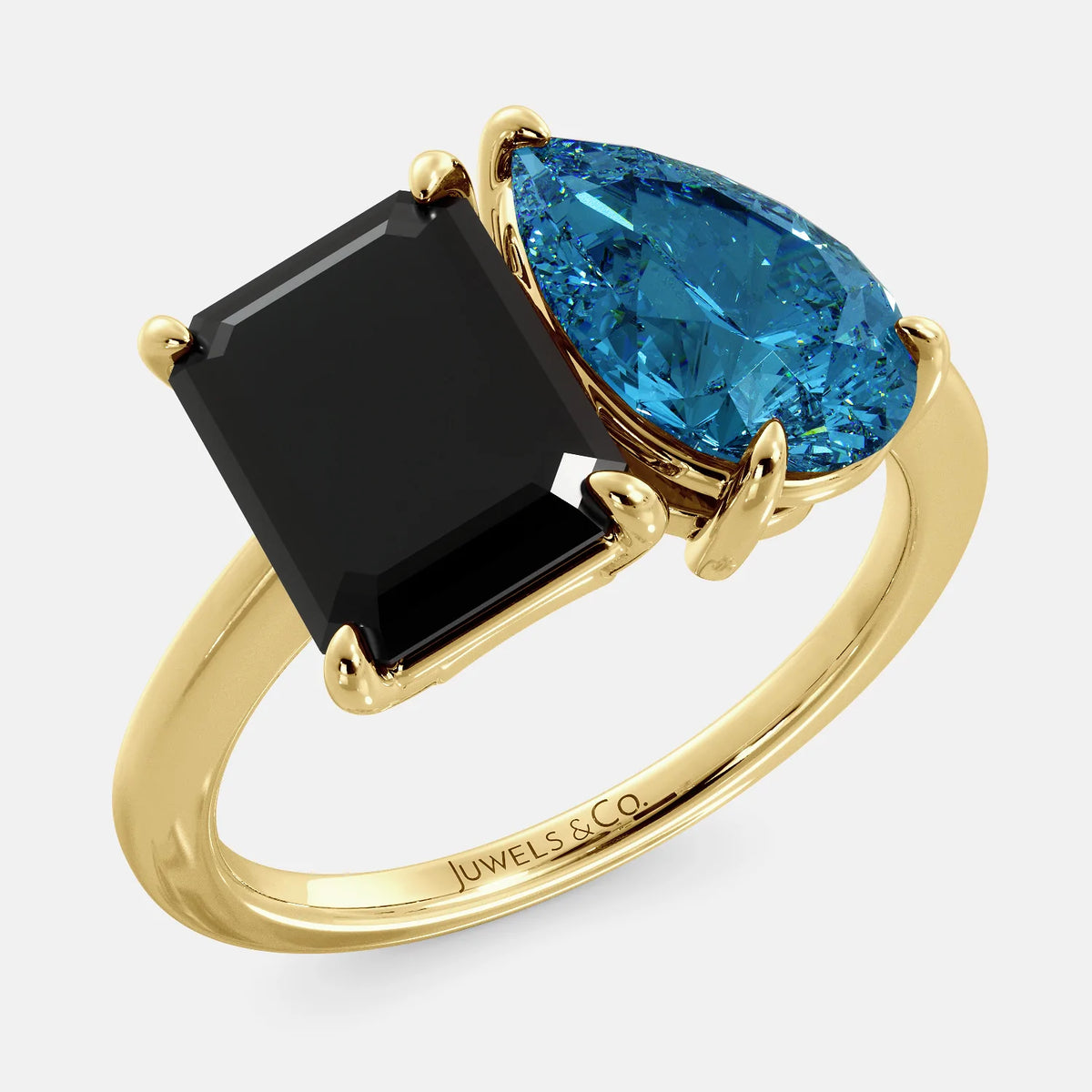 A toi et moi ring with a onyx stone in emerald cut and a pear-shaped stone. The onyx is a deep dark color and the pear-shaped stone can be customized to represent the birth month stone of the wearer or a loved one. The ring is made of 14k gold and is available in all sizes. This ring is a perfect gift for any occasion, and it can be customized to make it truly unique.